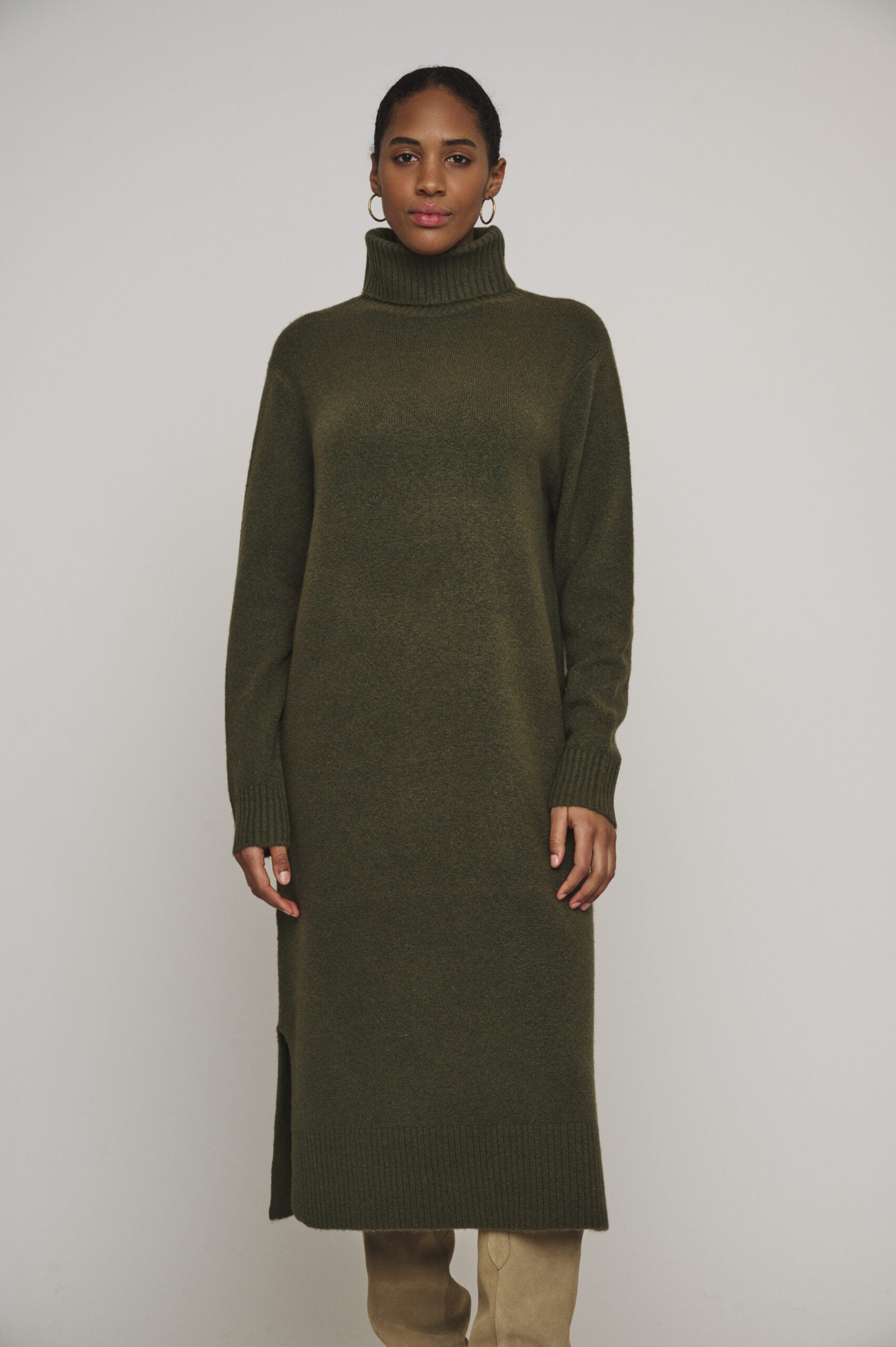 Get cozy in this Hunter Green Tenzil dress from Rino & Pelle, featuring a fun turtleneck, ribbed accents, trendy side slits, and unbeatable comfort. Pair with knee-high boots and you're ready to rock!