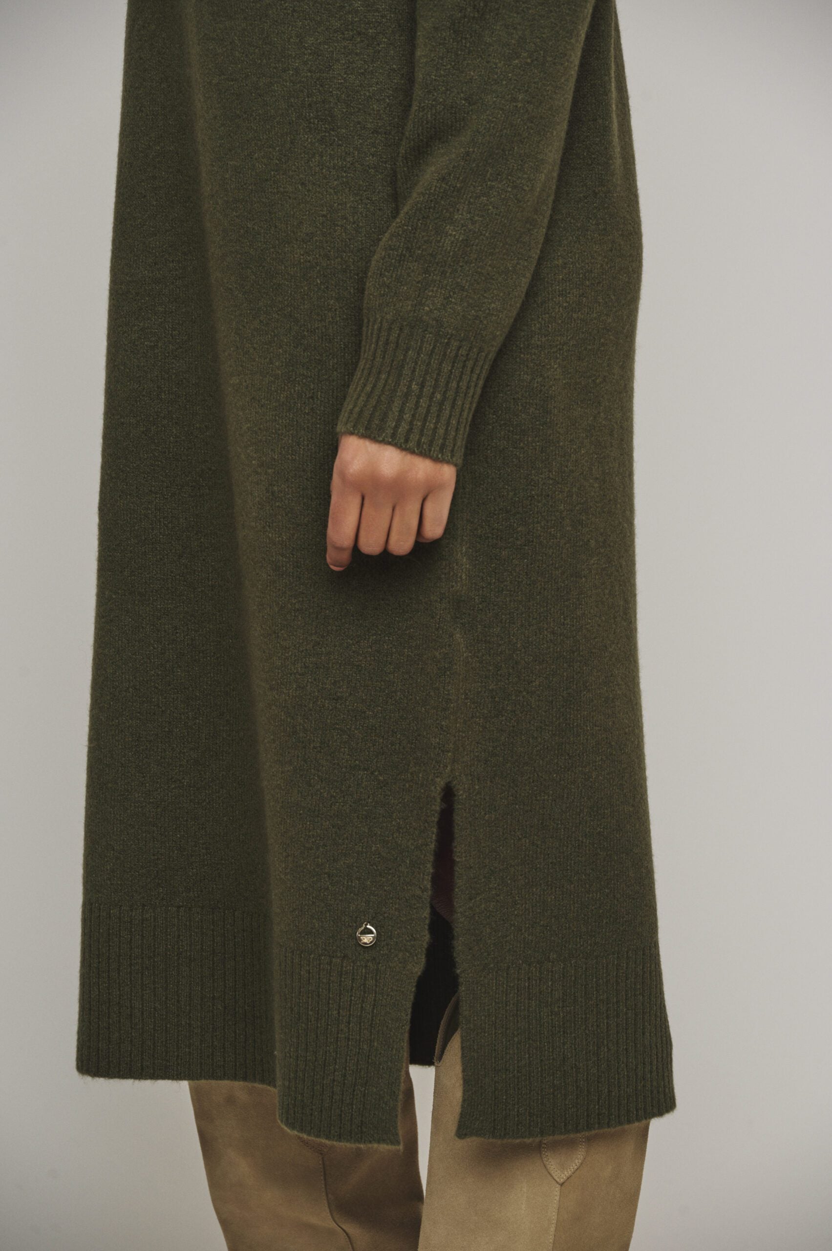 Get cozy in this Hunter Green Tenzil dress from Rino & Pelle, featuring a fun turtleneck, ribbed accents, trendy side slits, and unbeatable comfort. Pair with knee-high boots and you're ready to rock!