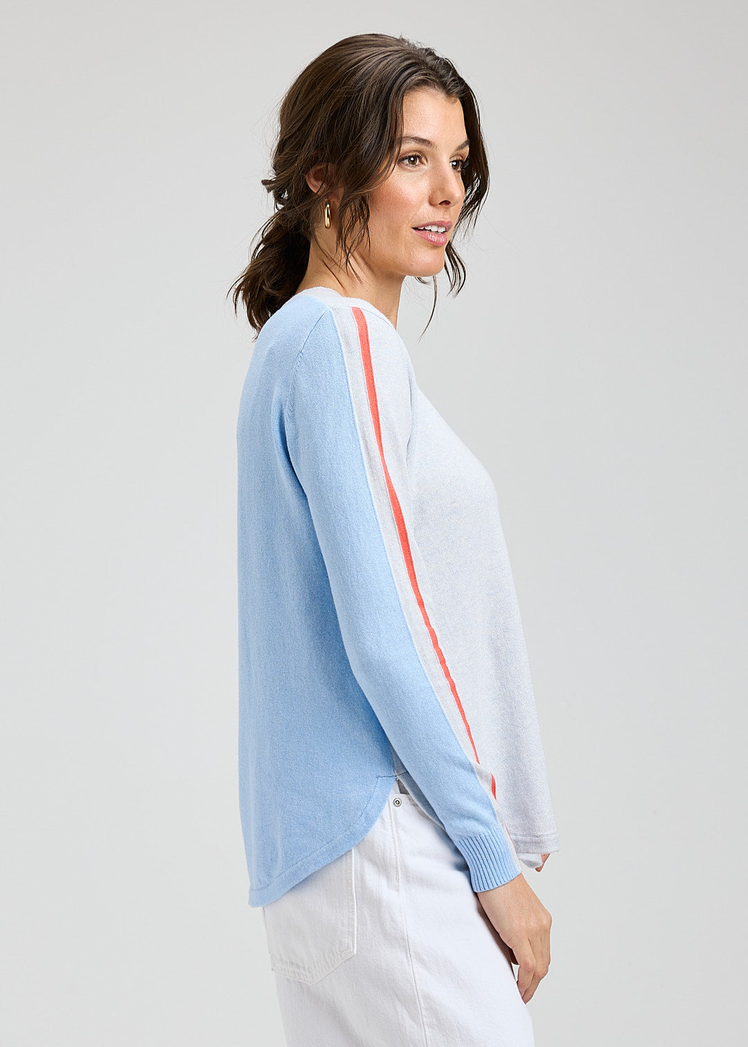 Woman wearing a light blue cardigan with a white background