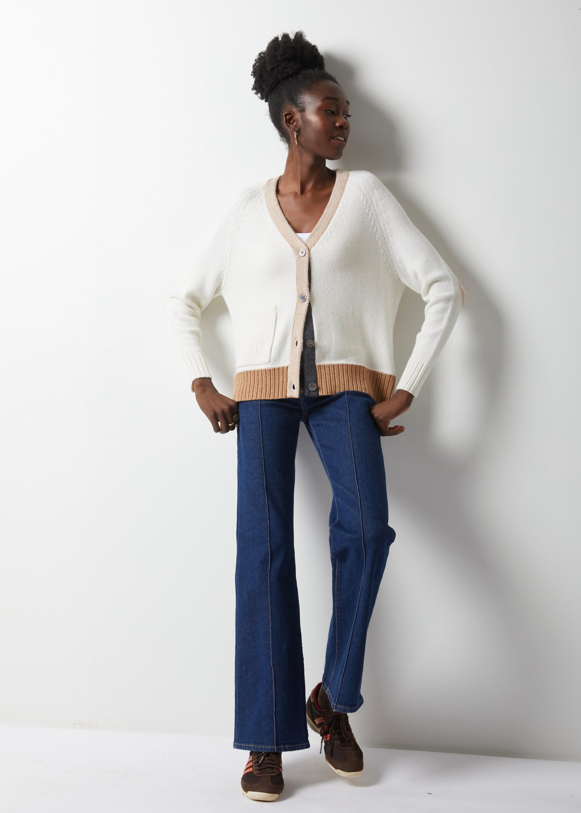 Get ready to fall in love with fashion all over again, thanks to this White Elbow Patch Cardi by Zaket &amp; Plover. Cozy up in a luxurious cashmere cotton blend with soft white details and a touch of camel and charcoal grey to add a pop of color. The camel elbow patches are the perfect playful touch, giving it that little something extra. lemon cyprus boutique