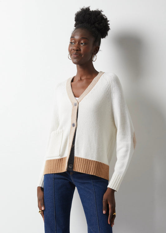 Get ready to fall in love with fashion all over again, thanks to this White Elbow Patch Cardi by Zaket &amp; Plover. Cozy up in a luxurious cashmere cotton blend with soft white details and a touch of camel and charcoal grey to add a pop of color. The camel elbow patches are the perfect playful touch, giving it that little something extra. lemon cyprus boutique