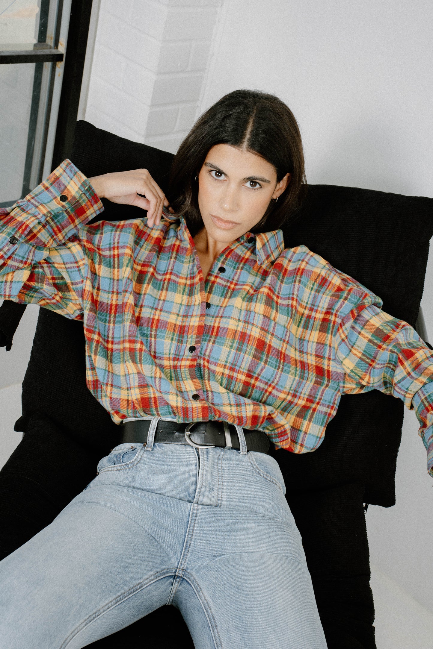 Woman wearing Chalet Plaid flannel shirt by Black & Liberty in sky blue, red, mustard, and green
