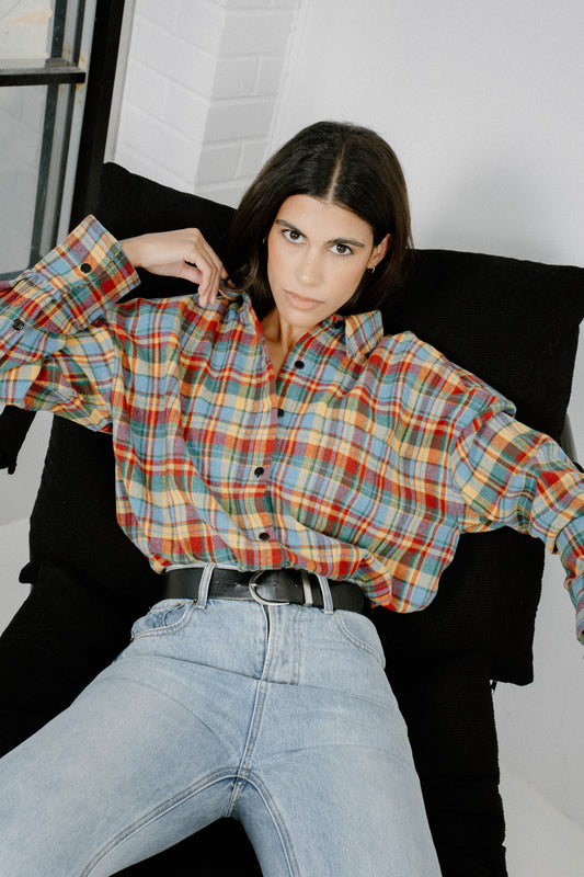Woman wearing Chalet Plaid flannel shirt by Black & Liberty in sky blue, red, mustard, and green