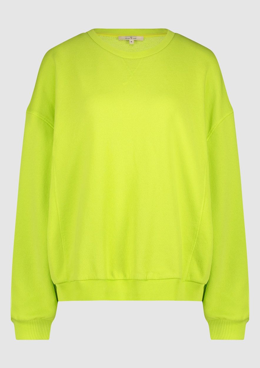 Nikita Sweatshirt by Circle of Trust features a crew neck and rib-knitted cuffs in a vibrant neon green hue. lemon cyprus boutique