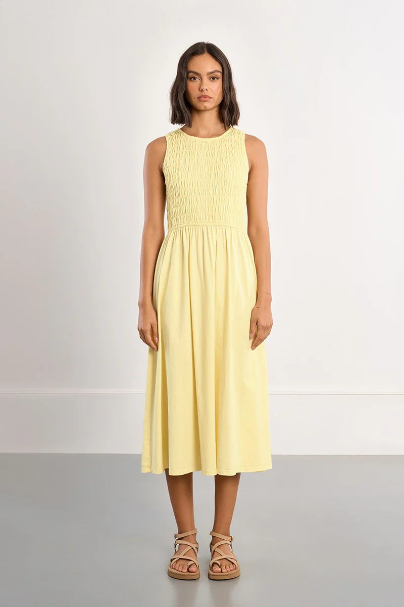 Woman wearing a yellow dress on a white background
