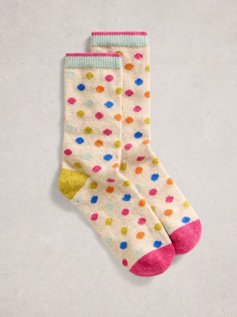 Pair of socks with colorful polka dots on a light gray background