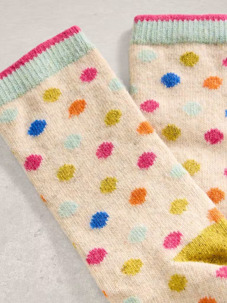 Pair of socks with colorful polka dot pattern on a neutral background