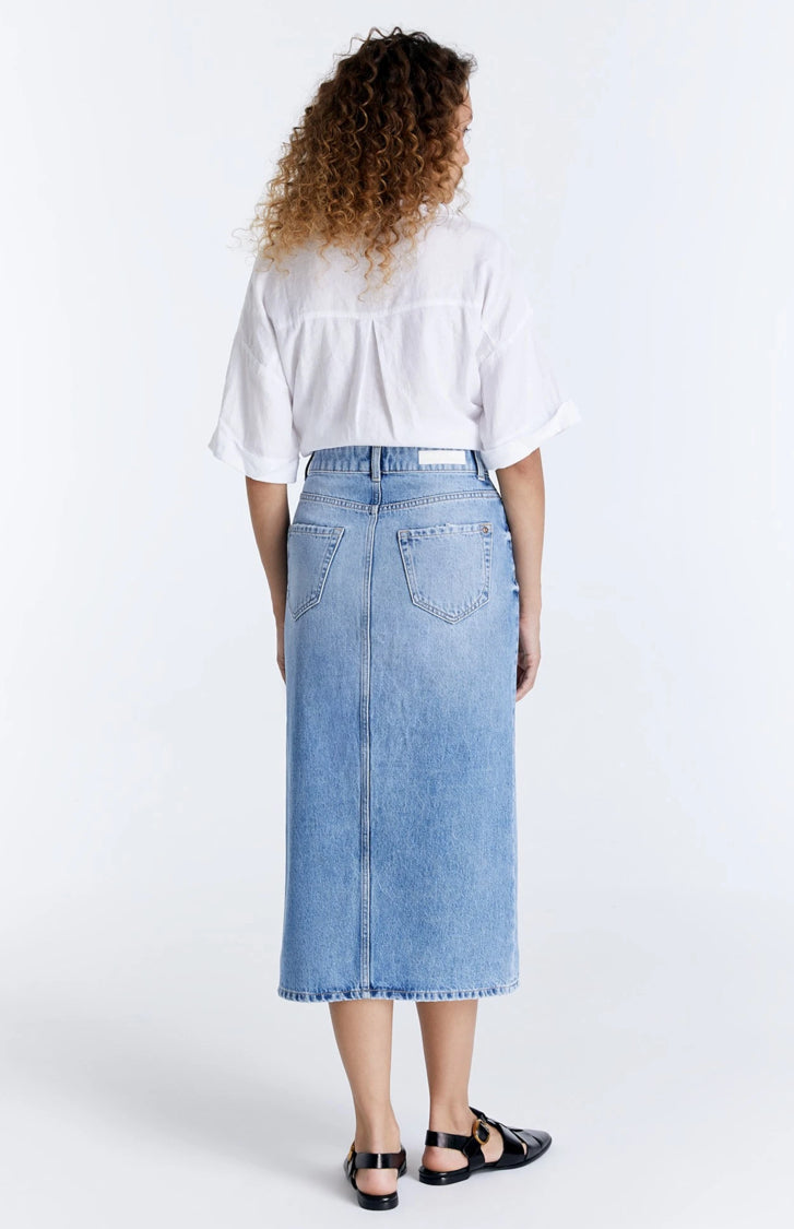 Introducing the "Helen" Denim Skirt by Cup of Joe – your new go-to for chic comfort. With its light blue wash and slim fit, this mid-waist skirt flatters every figure. Featuring five pockets and a front slit, it's both practical and stylish. Perfect for any occasion, the "Helen" skirt promises all-day comfort and effortless style.