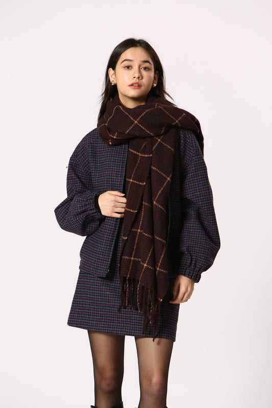 Woman wearing a patterned coat on a white background
