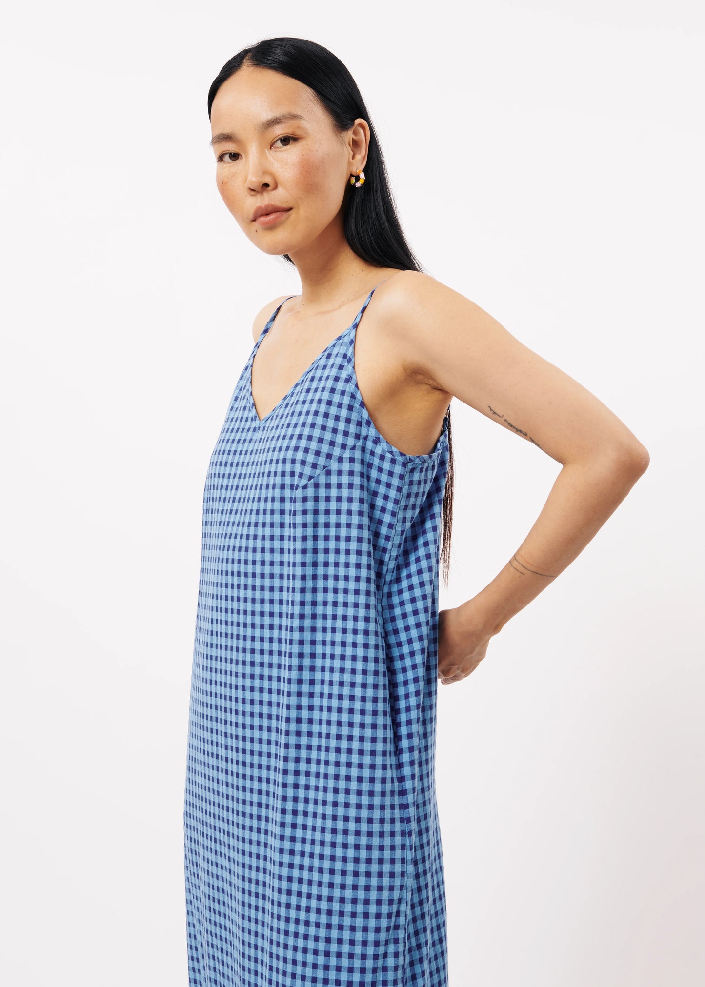 The FRNCH Neha Dress features a stylish Vichy gingham pattern in two tone blue and a straight, form-flattering cut, pockets and thin straps. Perfect for an effortless and chic look while out and about in town, day or night.