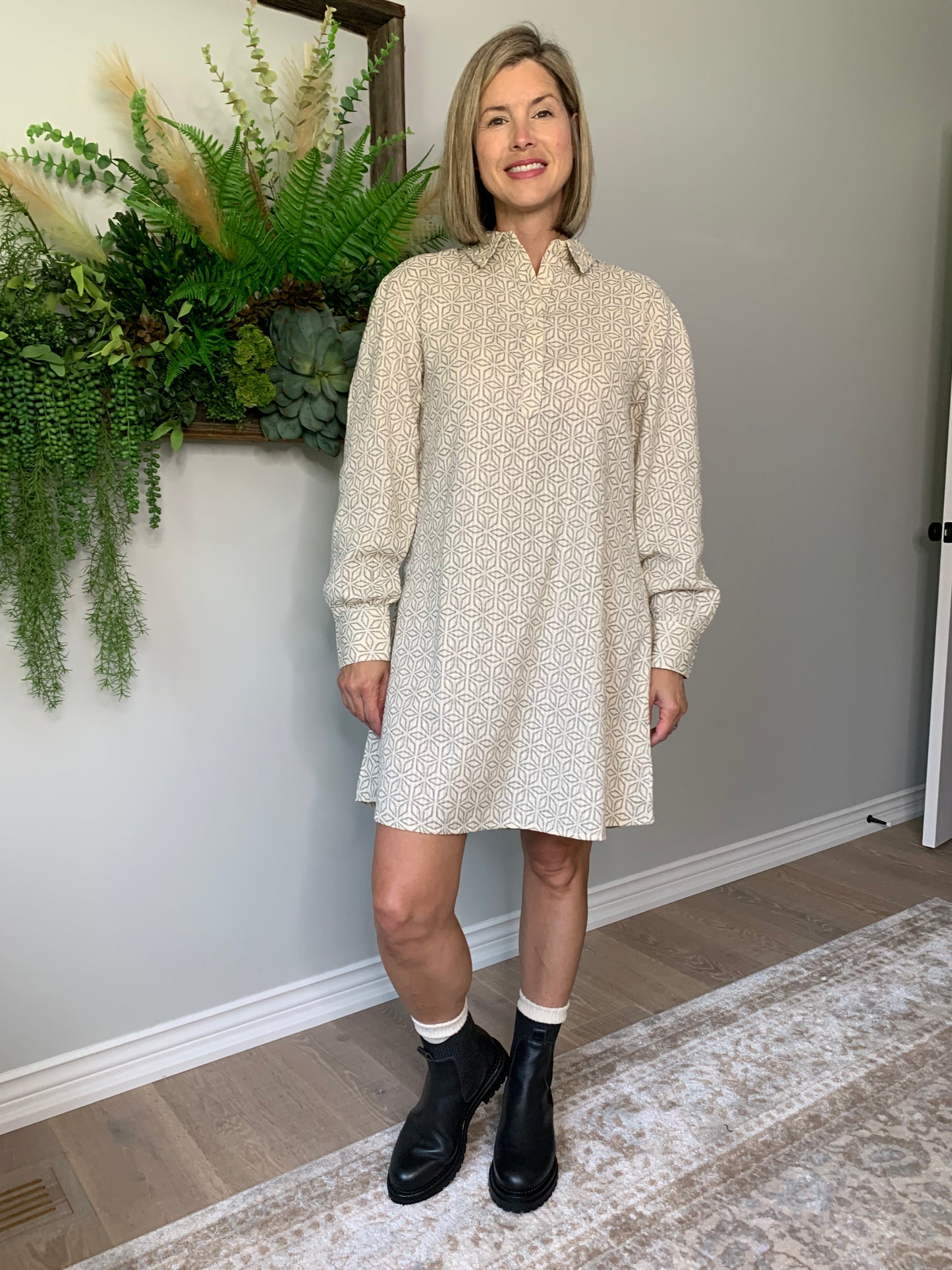 The Rena dress by FRNCH features a shirt collar, long balloon sleeves, and a button placket for a look that's comfortable and stylish. geometric pattern in black is woven into the cotton fabric with a cream background. lemon cyprus boutique