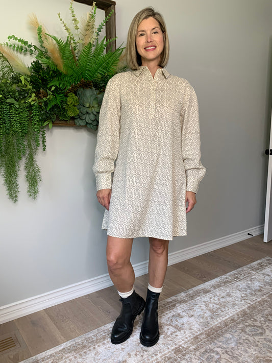 The Rena dress by FRNCH features a shirt collar, long balloon sleeves, and a button placket for a look that's comfortable and stylish. geometric pattern in black is woven into the cotton fabric with a cream background. lemon cyprus boutique