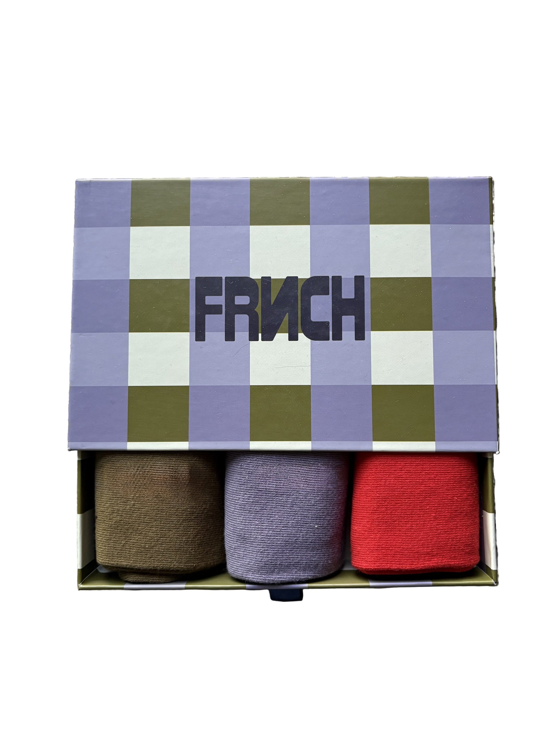 Three pairs of socks in a box with a checkered lid labeled 'Fruch' on a textured surface.