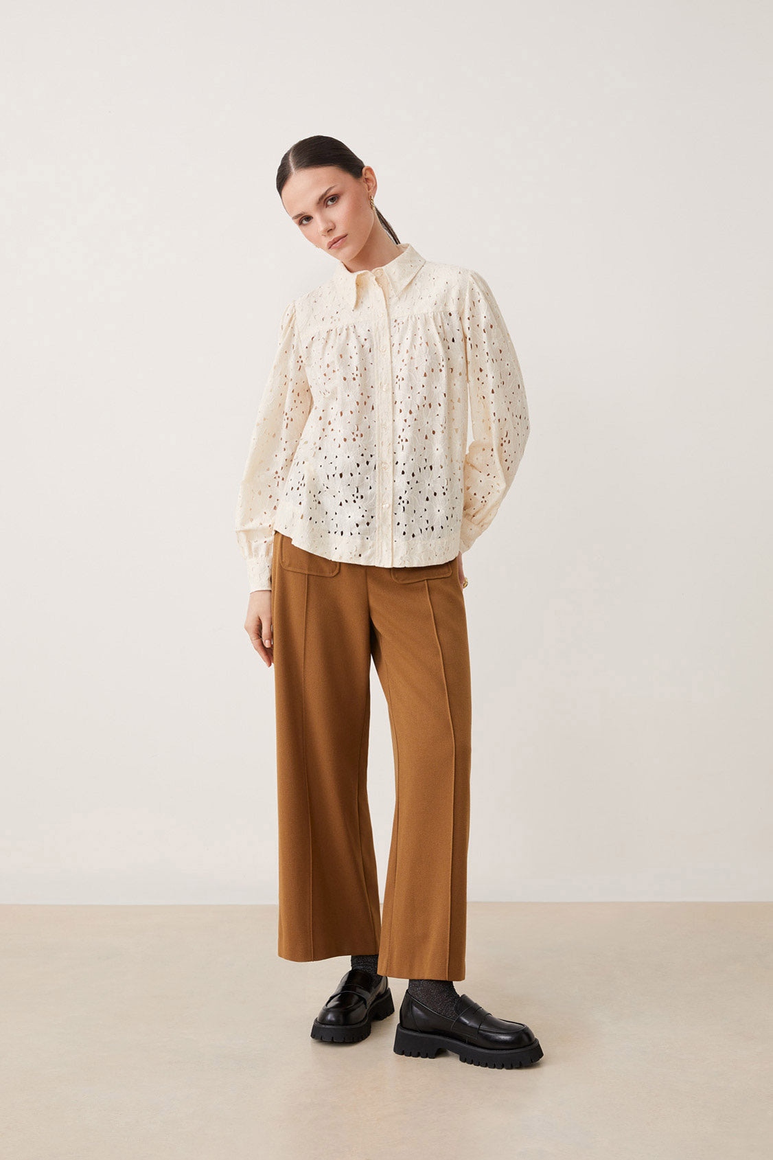 Elevate your style with this playful Guipure Lace Blouse by Suncoo from Paris. Featuring long sleeves and a buttoned closure, this blouse boasts a shirt collar for a sophisticated touch. The delicate guipure lace adds a touch of femininity to this vanilla coloured top.