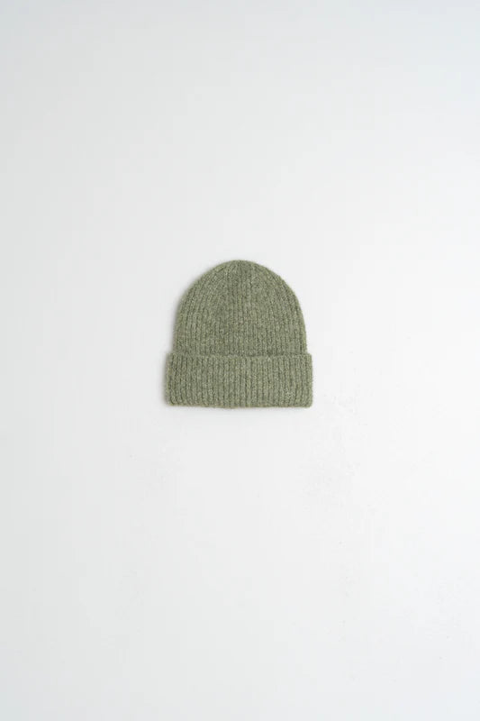 Green knit beanie on a white background