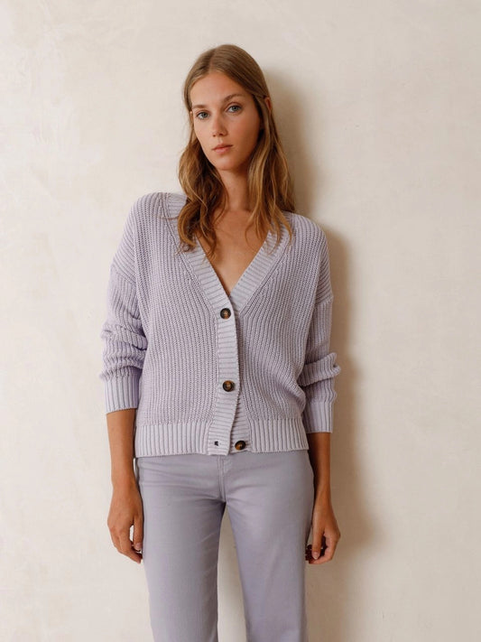 The Men's Style Knitted Cardigan by Indi &amp; Cold is the perfect addition to your wardrobe this season in this beautiful lilac colour. Made in Italy with organic cotton, its V-neck and hip-length square cut prioritize comfort and style.