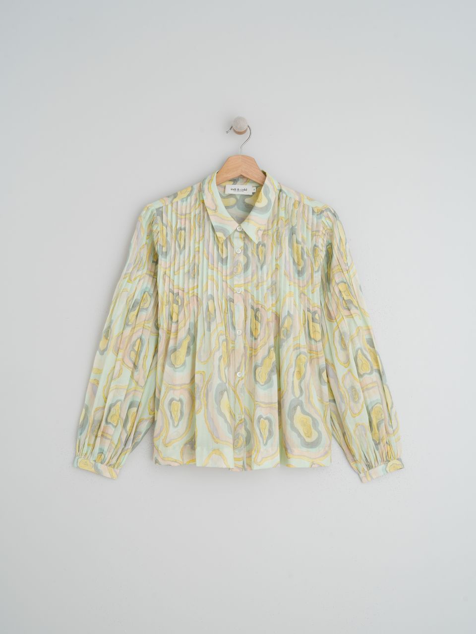 If you're looking for a shirt that's different, you're in the right place. This Pleated Geode long sleeve, fitted-shoulder shirt by Indi &amp; Cold has light pleats all over the top and sleeves. The voile fabric makes it light, voluminous and very cool for those slightly warmer days.