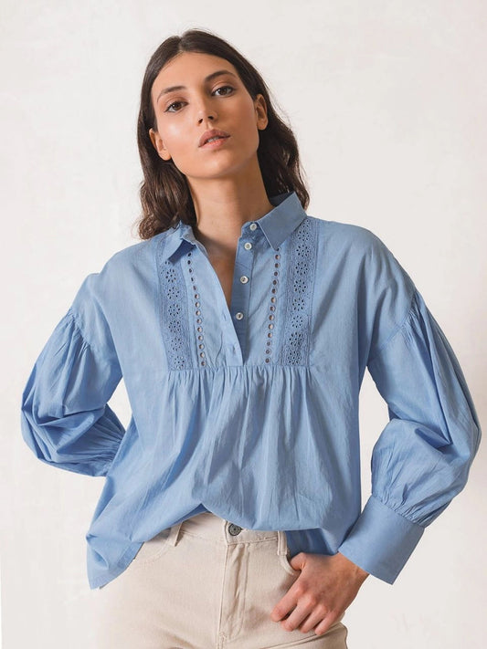 indi and cold schiffley embroidered blouse in sky blue. Shirt collar, dropped shoulder, long billowy sleeves with cute button cuffs, partial front buttonstand with beautiful embroidered accents & cut-outs - this blouse's square & relaxed fit will have you swooning. lemon cyprus boutique