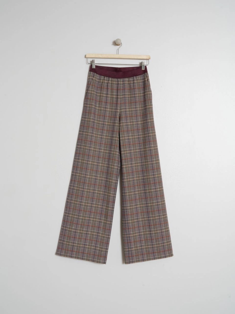 these indi & cold tartan trousers in burgundy tomes with a touch of blue are about to become your new go-to! The elastic waistband ensures a comfy fit, while the French front pockets and a flowy maxi length give it that cool, everyday look.  lemon cyprus boutique