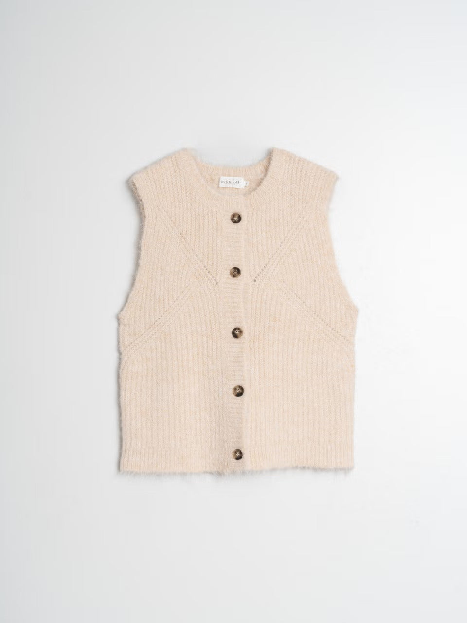 Elevate your style with this knitted vest cardigan by Indi &amp; Cold. Its sleek design and beutiful cream colour allows for easy layering over a tee or lightweight sweater. The shoulder placement and wide armholes provide flexibility. Fasten it with the charming button closure in the front. The playful ribbed fabric adds a unique touch.