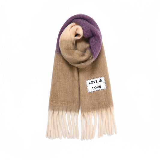 Scarf with a tag reading 'LOVE IS LOVE' on a tan background