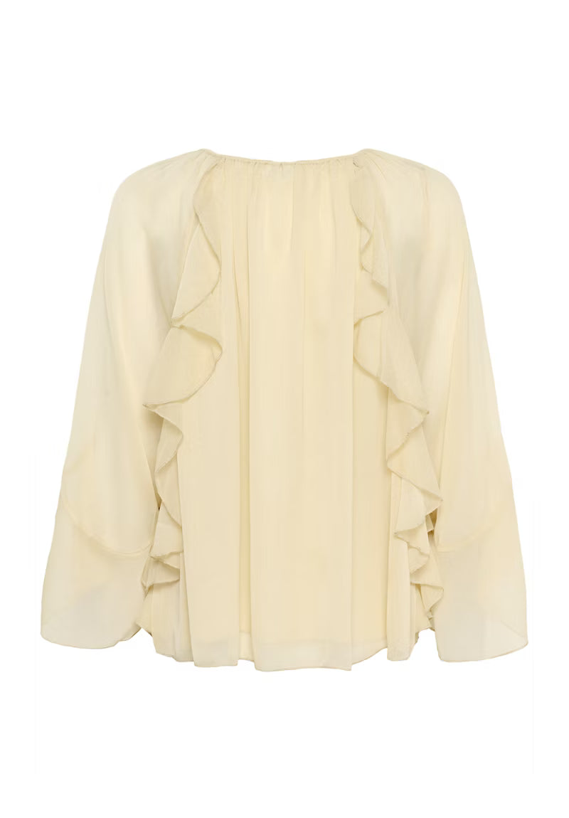 Cream-colored blouse with ruffled details on a white background