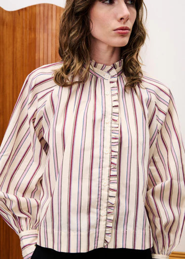 Woman wearing a striped blouse with a wooden background