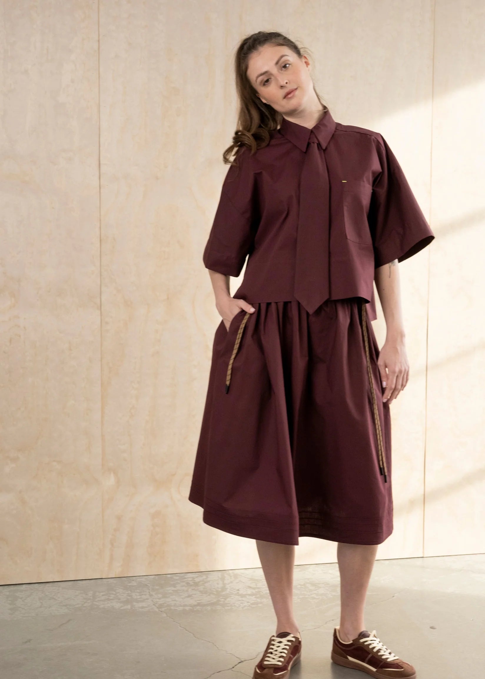 Burgundy cropped cotton poplin shirt with point collar and neon bar tack accents by Bodybag by Jude