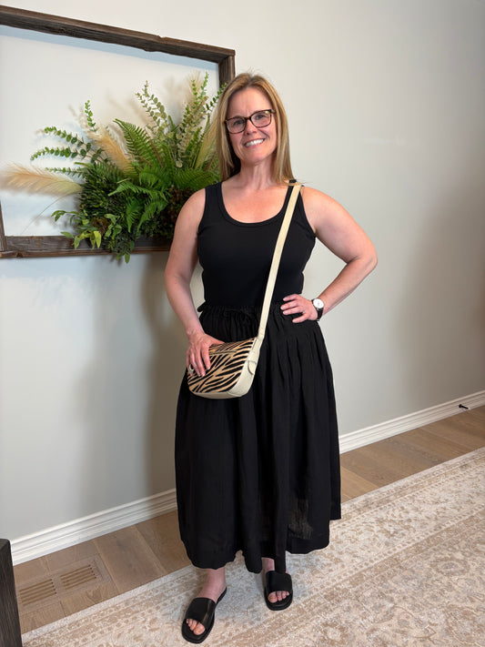 Get ready for some serious twirl action in the Jonie Skirt by Naif. Made from 100% linen, this black full skirt features an elastic waist with a tie front, creating the perfect fit. The beautiful pleating detail adds a touch of elegance to this playful piece.