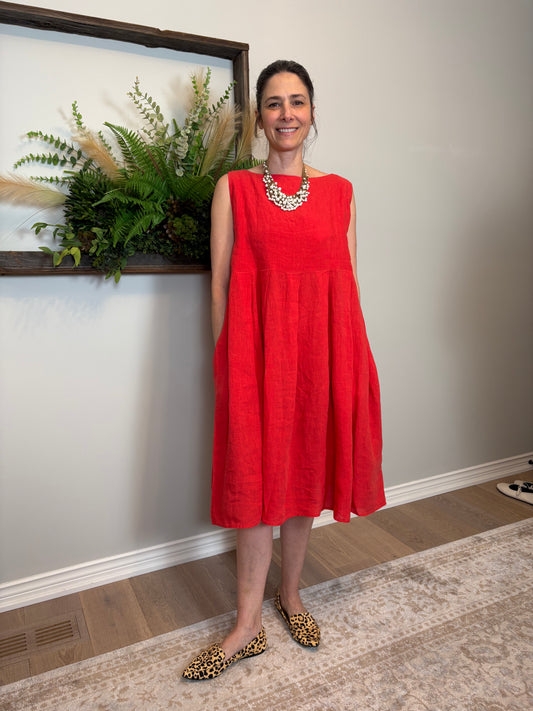 This poppy red Lully Dress by Naif is a standout piece that’s equal parts bold and breezy. Made from 100% linen, it’s lightweight and breathable—perfect for warm days. The sleeveless cut and empire waist give it a relaxed babydoll shape that feels easy and flattering, while the loose A-line fit adds to the laid-back vibe. Buttons down the back add a sweet, unexpected detail