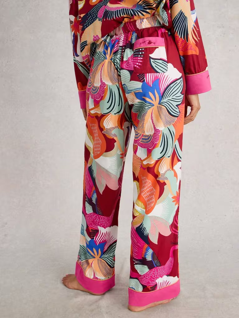 Colorful floral-patterned pants with a red background