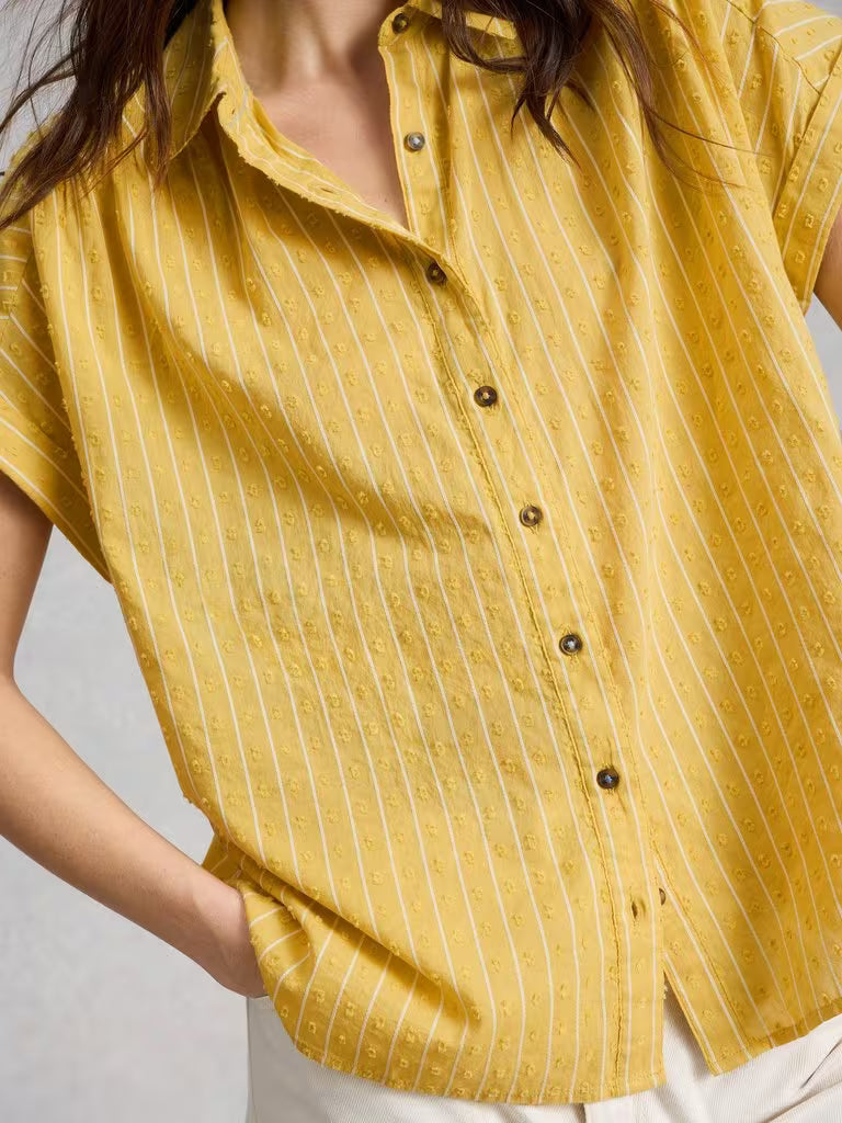 Yellow striped shirt worn by a person on a light gray background