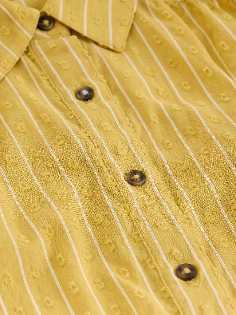 Close-up of a yellow shirt with white stripes and button details