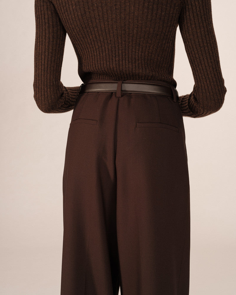Brown ribbed sweater and wide-leg pants on a beige background
