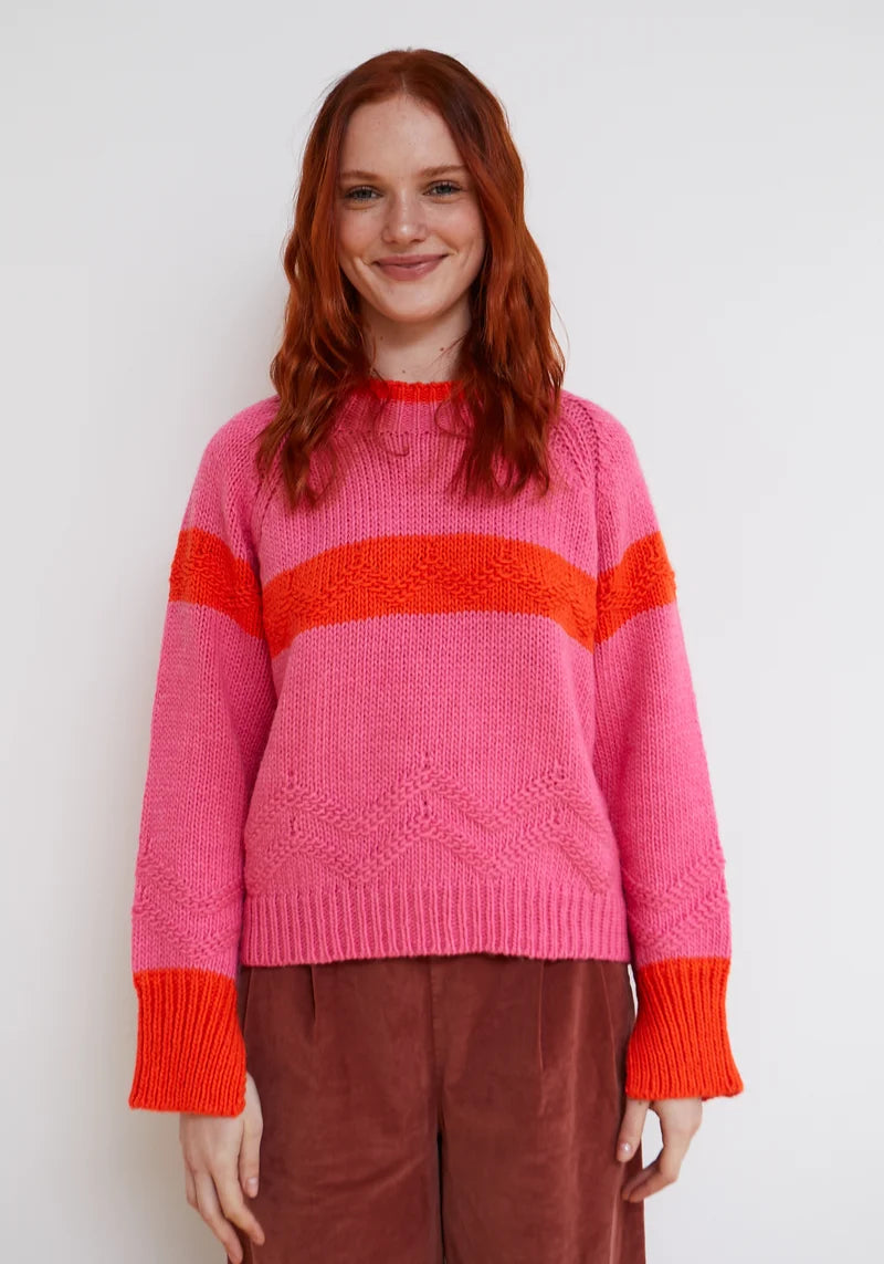 Woman wearing pink and orange Carmelo Pink Candy Sweater by Dr Bloom, front view