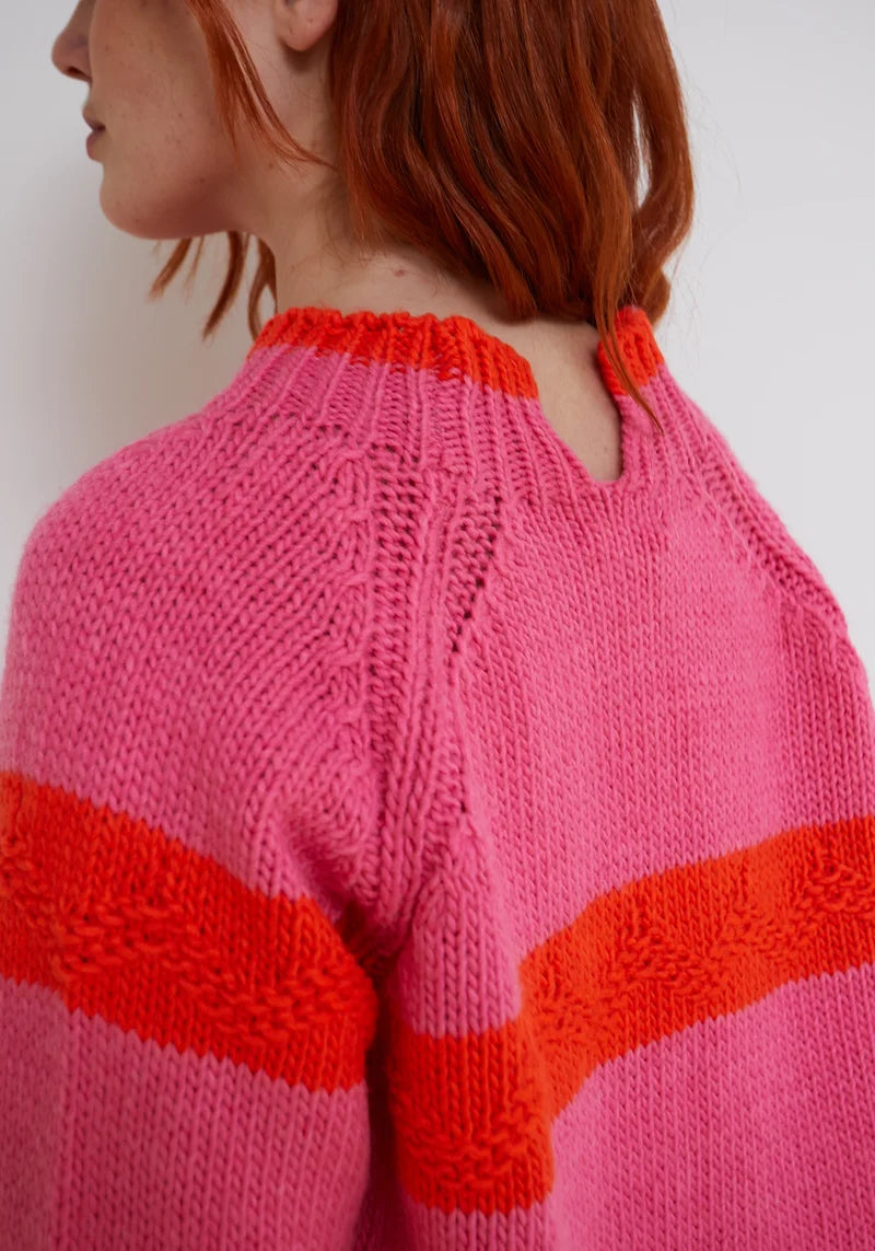 Woman wearing pink and orange Carmelo Pink Candy Sweater by Dr Bloom, front view