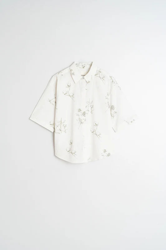 White floral blouse on a light gray background