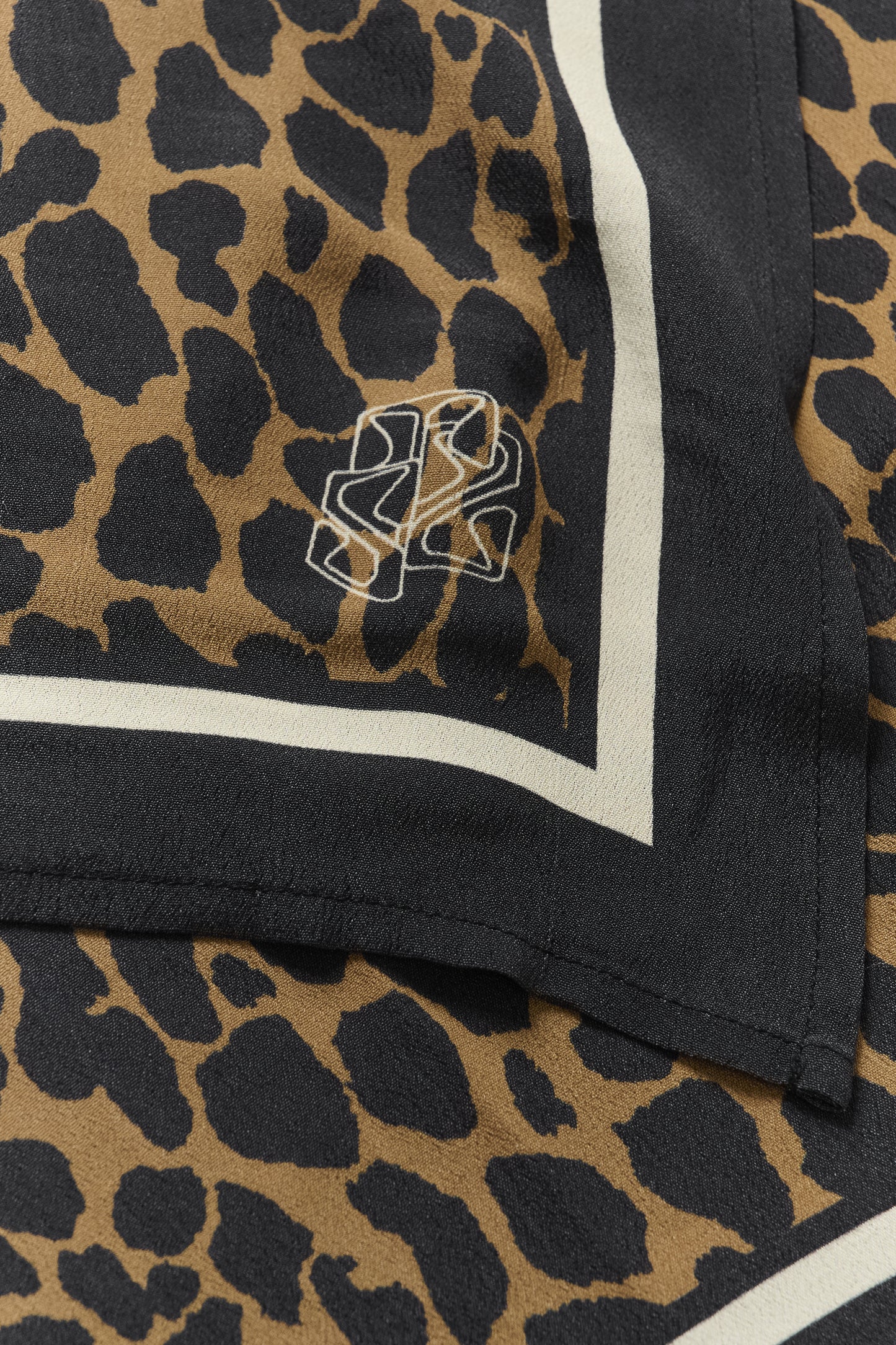Leopard print fabric with a logo in the corner