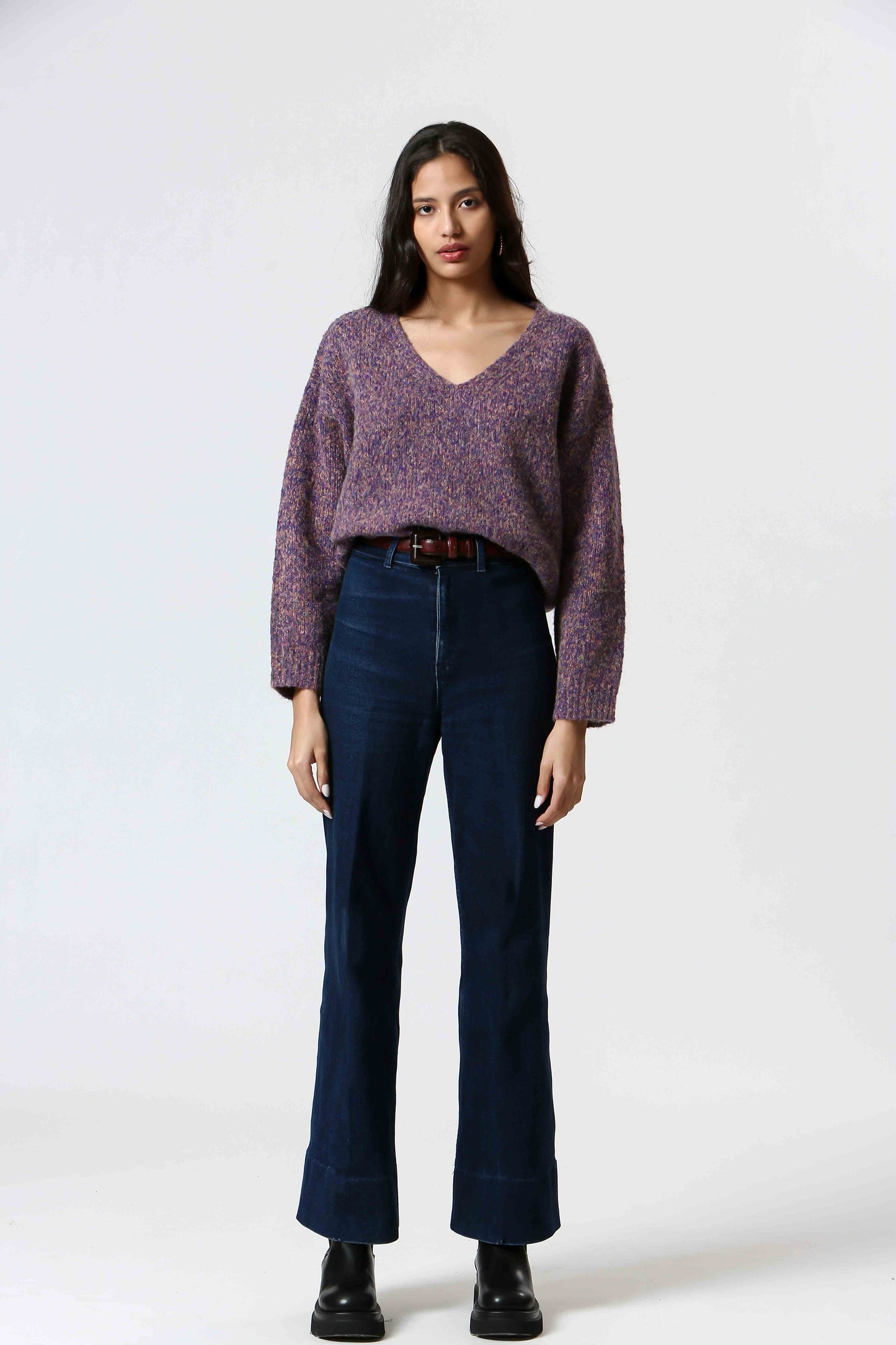 Get lost in the dreamy Purple Haze Sweater by The Korner. A melange of purple hues mixed with a touch of coral make this cozy v-neck a must-have. Perfect for adding a touch of cozy style to your wardrobe.