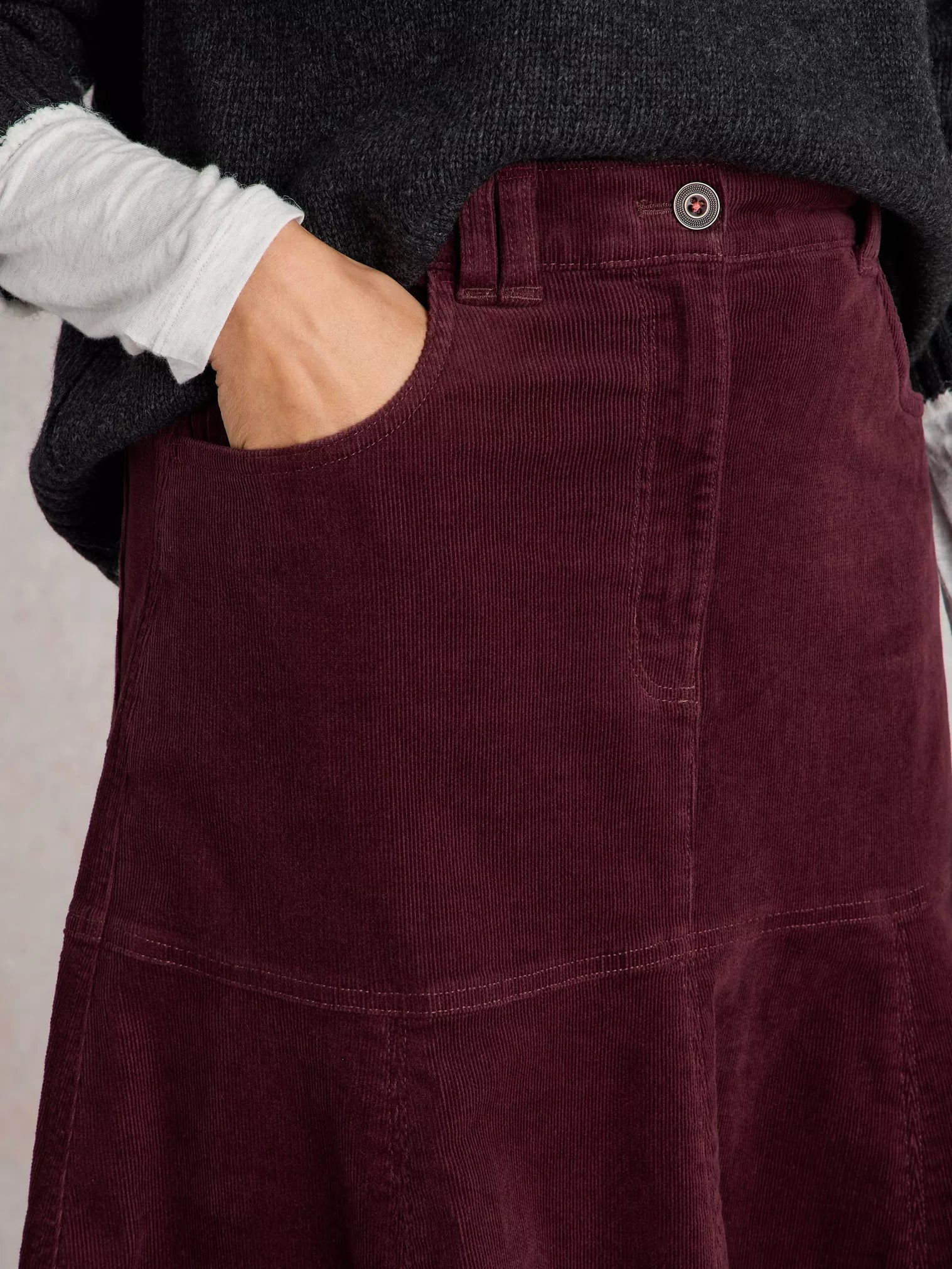 Revamp your wardrobe with The Quinn, a knee-high burgundy cord skirt from White Stuff. Its high waist and midi length make it the perfect addition to any outfit.