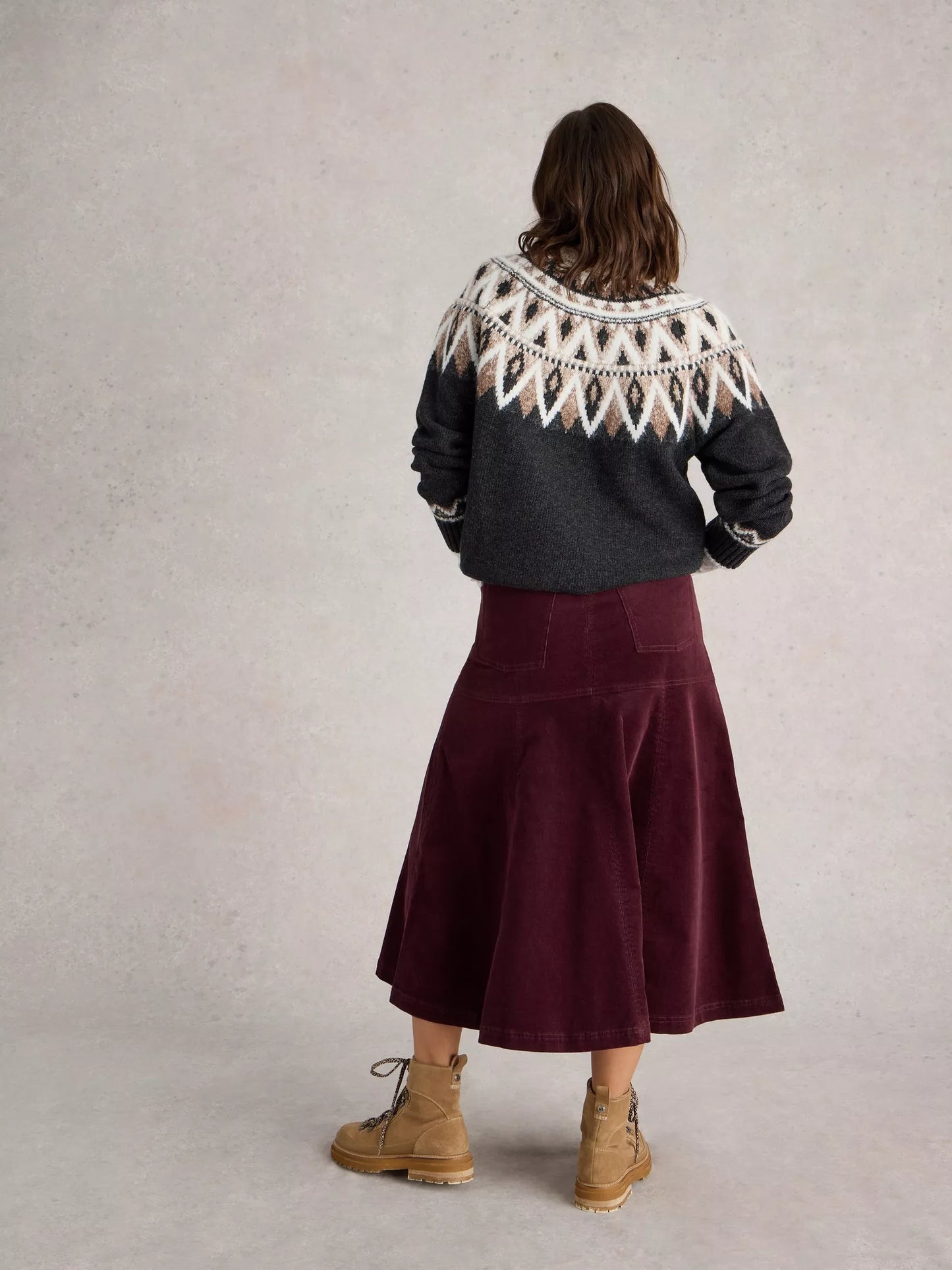 Revamp your wardrobe with The Quinn, a knee-high burgundy cord skirt from White Stuff. Its high waist and midi length make it the perfect addition to any outfit.