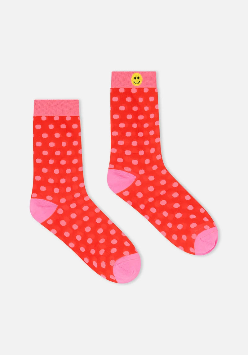 Red polka dot socks with pink accents on a white background
