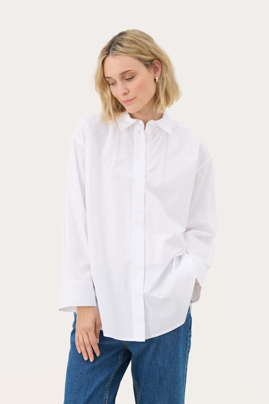 Woman wearing a white shirt and blue jeans on a white background