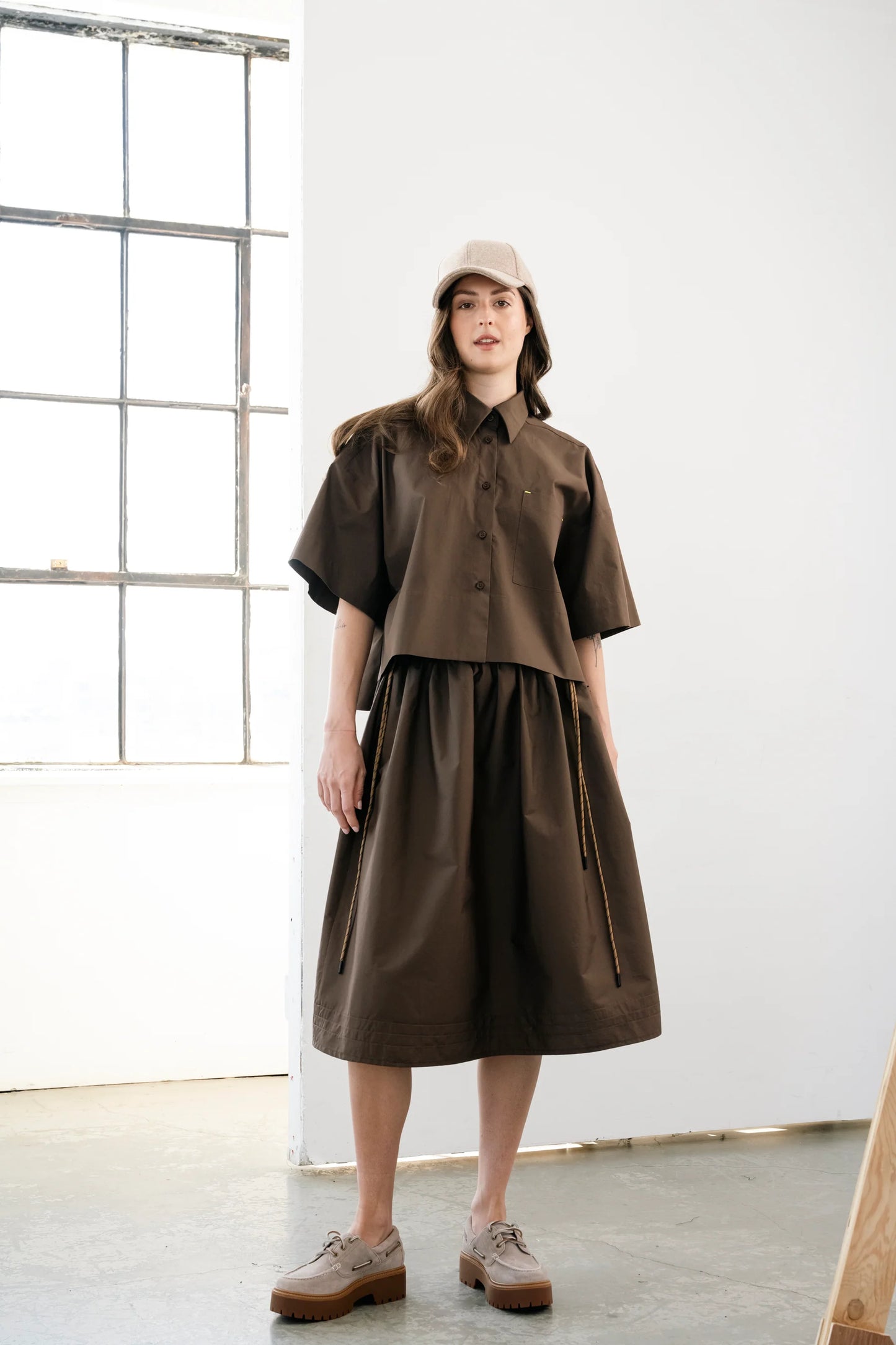 Brown voluminous cotton midi skirt with side cords and pockets by Bodybag by Jude