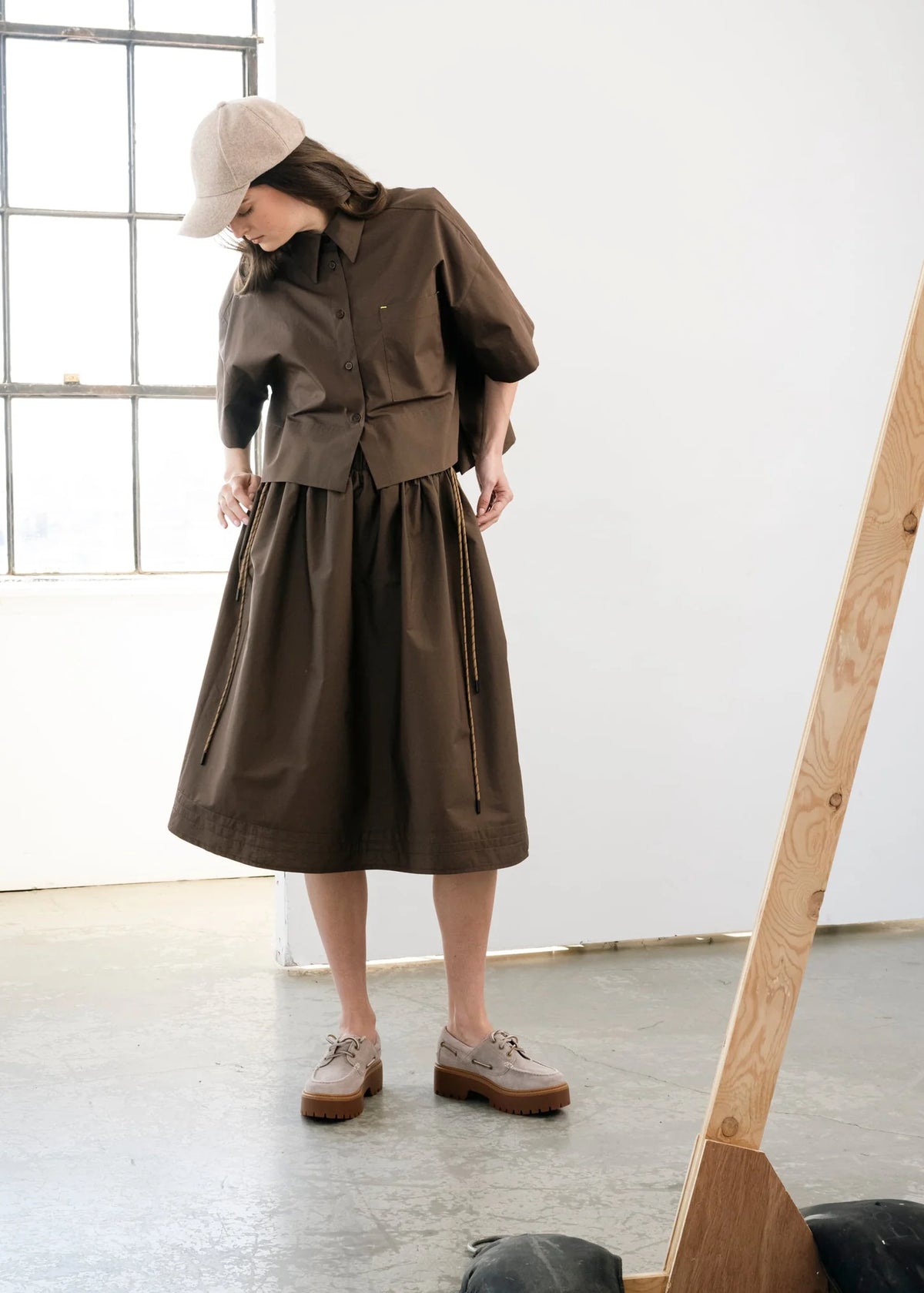 Brown voluminous cotton midi skirt with side cords and pockets by Bodybag by Jude