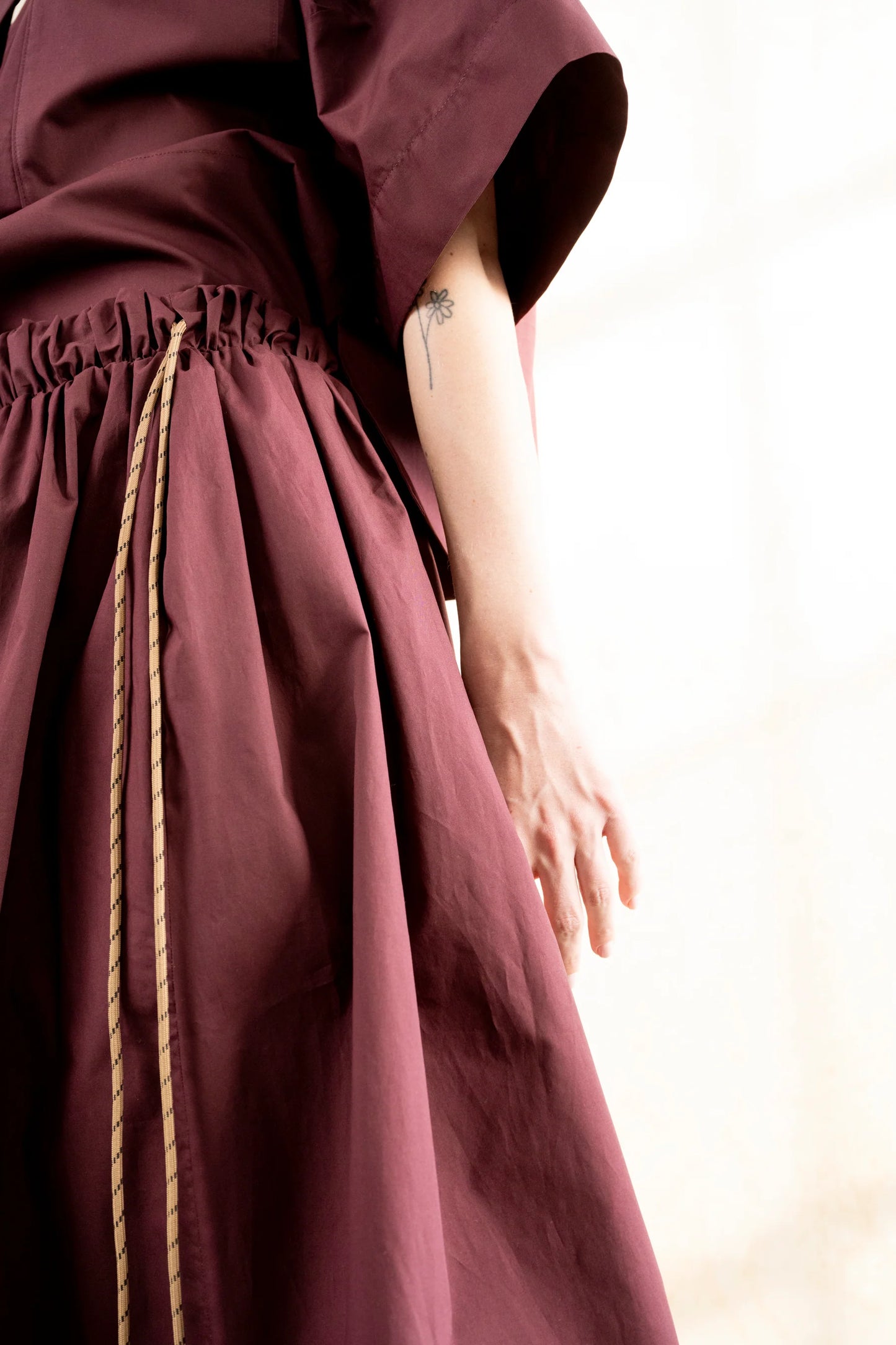 Burgundy voluminous cotton midi skirt with side cords and pockets by Bodybag by Jude