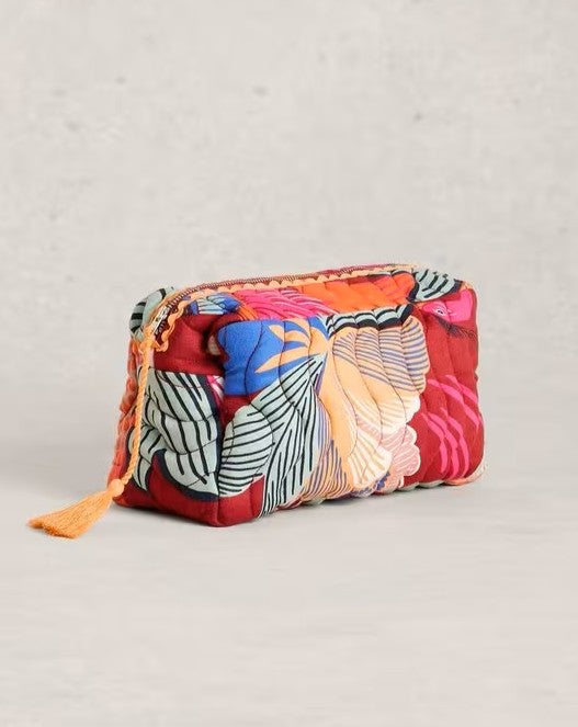 Colorful quilted pouch with floral pattern on a light gray background