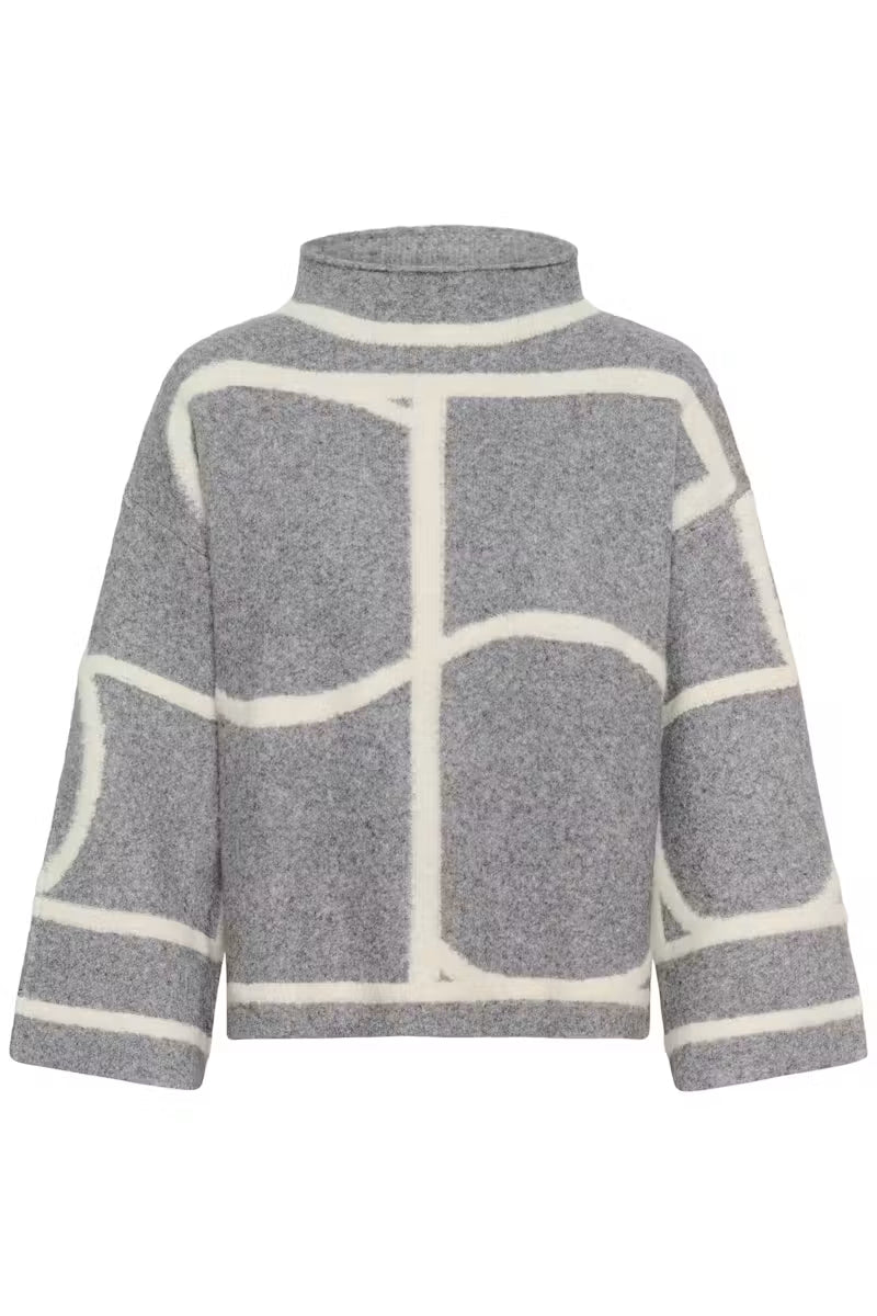 Woman wearing grey oversized sweater with ivory colour-block seaming by Soaked in Luxury, paired with black leather pants