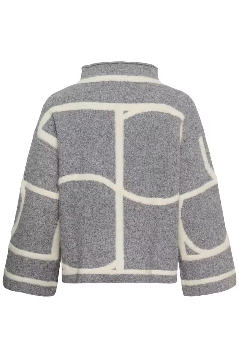 Woman wearing grey oversized sweater with ivory colour-block seaming by Soaked in Luxury, paired with black leather pants