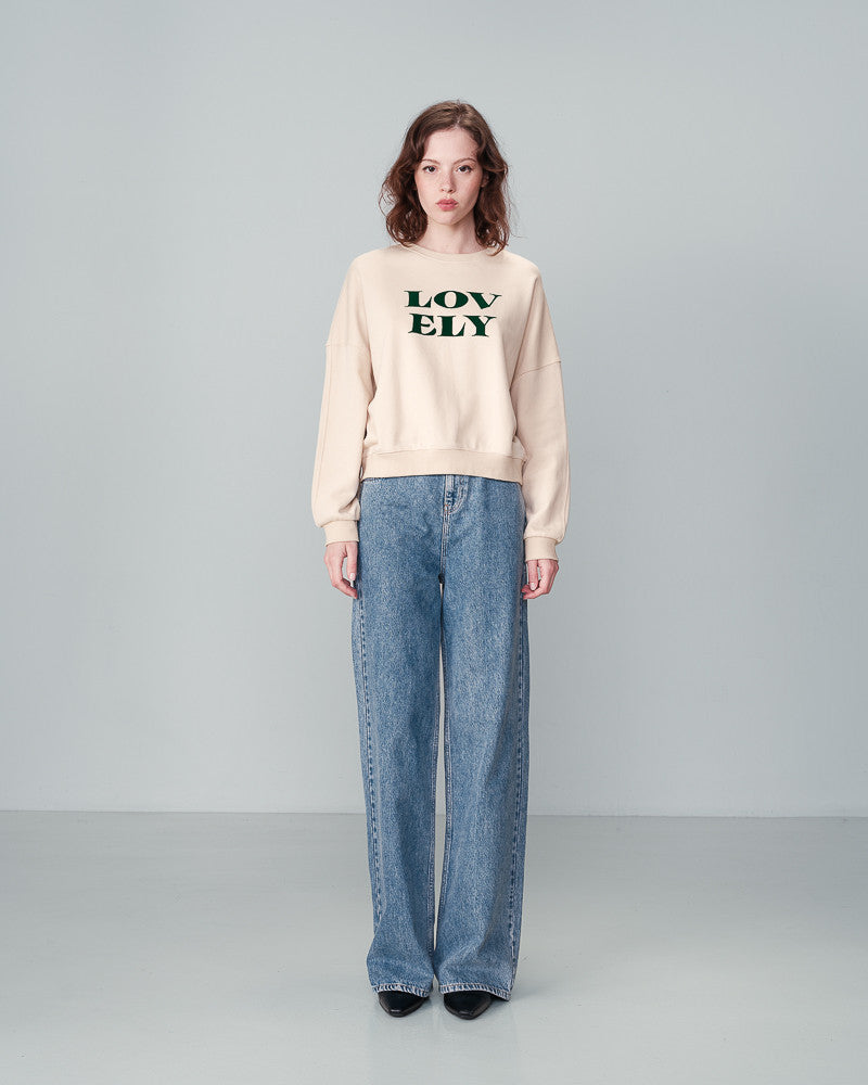 The&nbsp;NIGEL round neck sweatshirt by Grace &amp; Mila&nbsp;has a 'LOVELY' velvet print message in a beautiful hunter green on beige. Made from natural fibres, the warm and comfy&nbsp;NIGEL message sweater&nbsp;is a fall/winter essential. lemon cyprus boutique